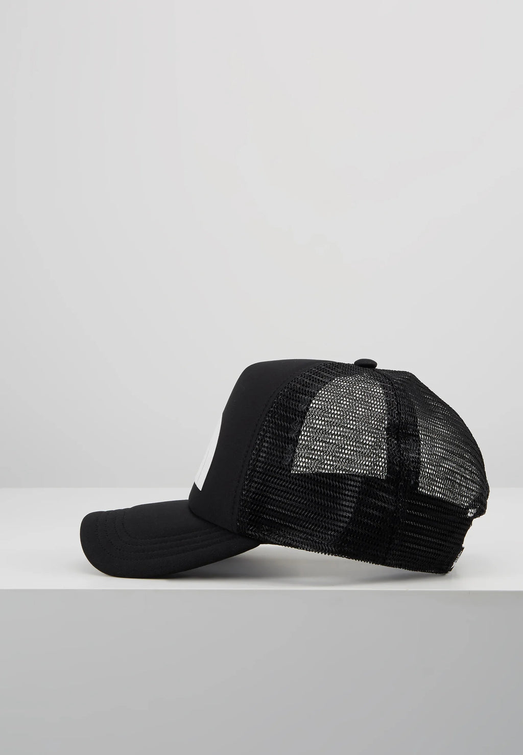 The North Face TNF Logo Trucker Cap in black and white.