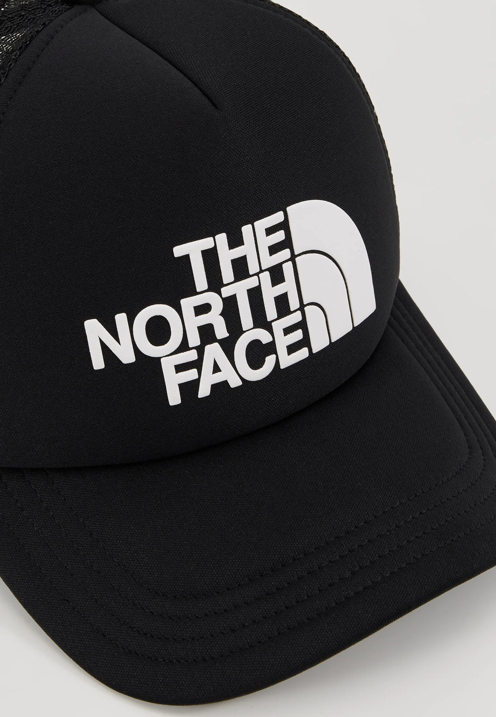The North Face TNF Logo Trucker Cap in black and white.