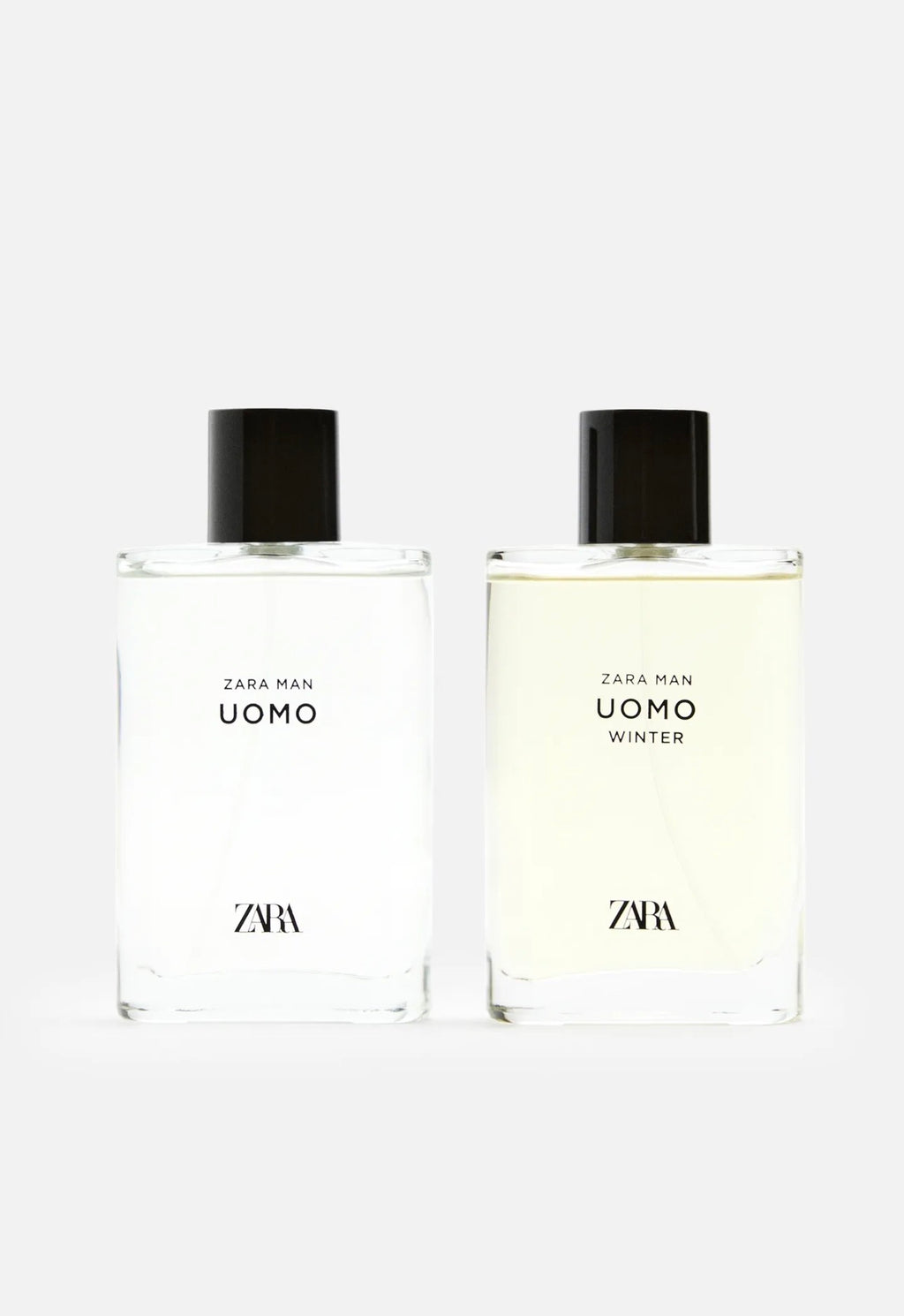 Two Zara Man Uomo fragrance bottles side by side on a light gray background, one with clear liquid and one with pale yellow liquid, both with black caps.