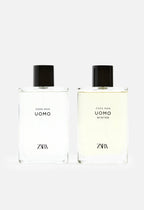 Two Zara Man Uomo fragrance bottles side by side on a light gray background, one with clear liquid and one with pale yellow liquid, both with black caps.