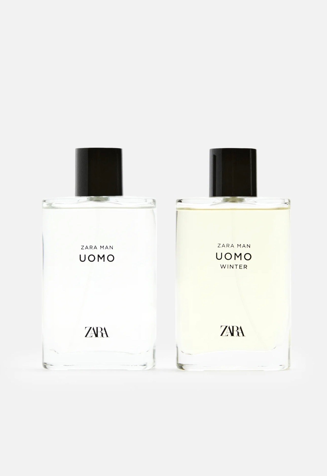 Two Zara Man Uomo fragrance bottles side by side on a light gray background, one with clear liquid and one with pale yellow liquid, both with black caps.